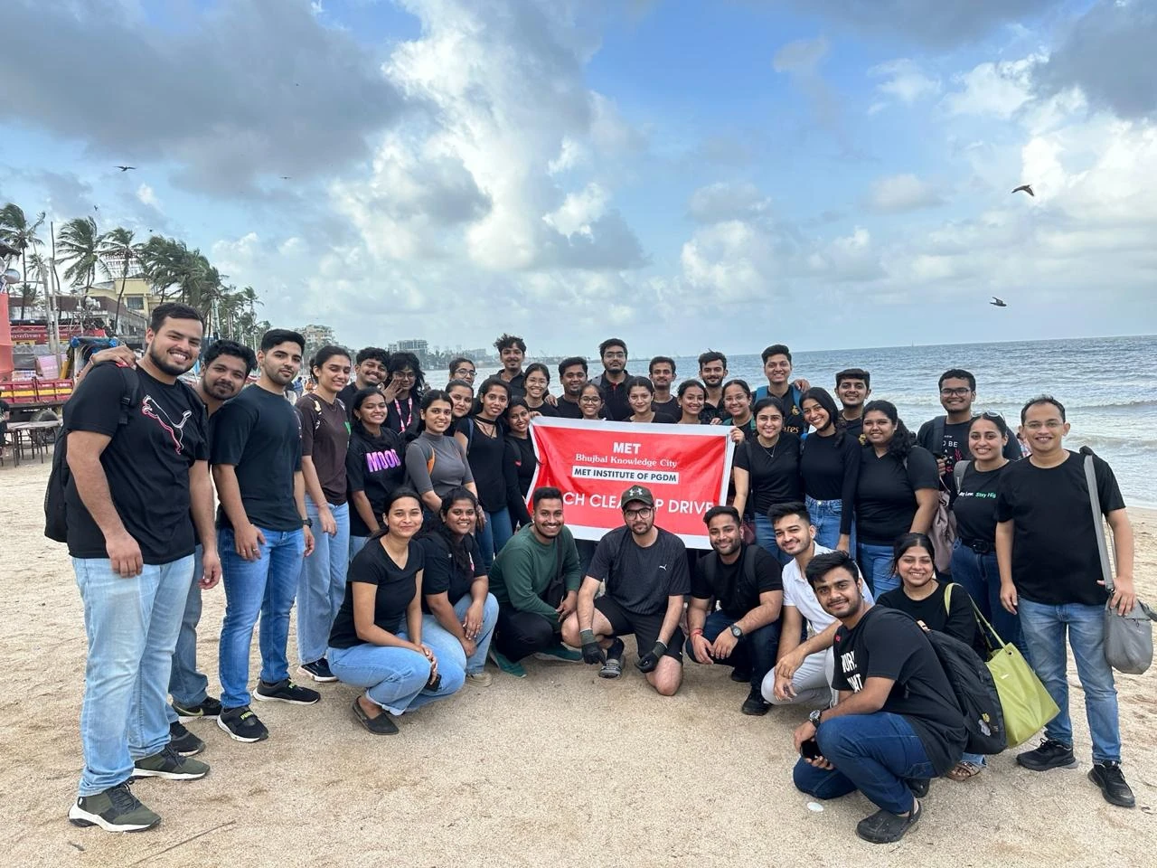 Volunteers gathered on the beach for a cleanup drive
