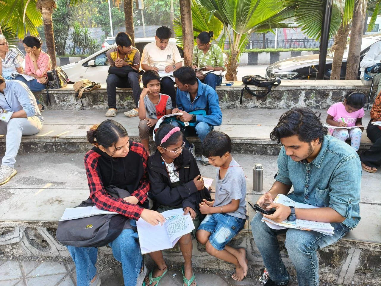 Children working in notebooks with volunteers